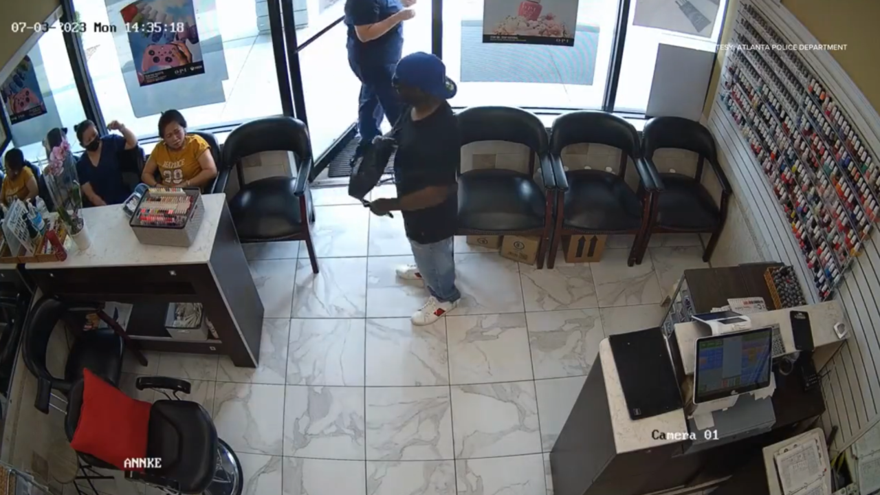 Security footage captured the moment when a suspect pretending to have a gun tried to hold up a nail salon, but no one inside was fazed.