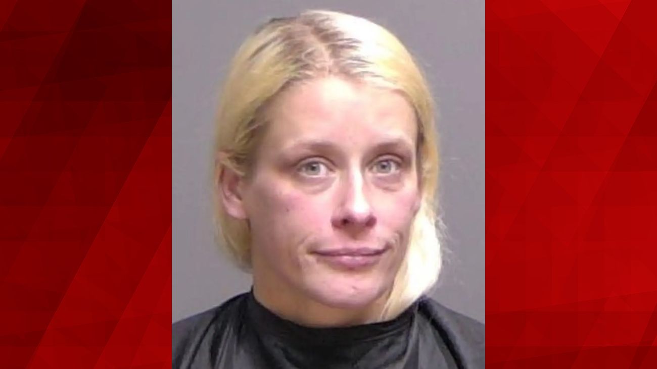 A woman was arrested after leaving her 11-year-old son in a hotel room with a dead man after her drug-filled sexual encounter with two men.